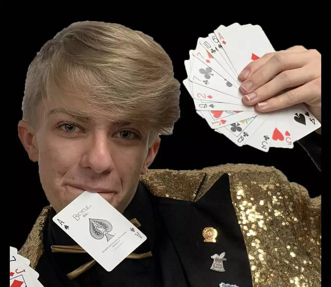 A man holding an ace of the car from his mouth