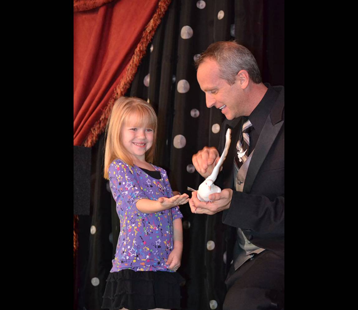 A little child being part of magic shows