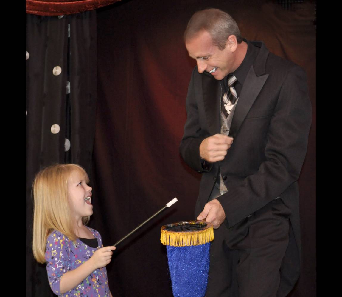 A magician asking a girl to do magic