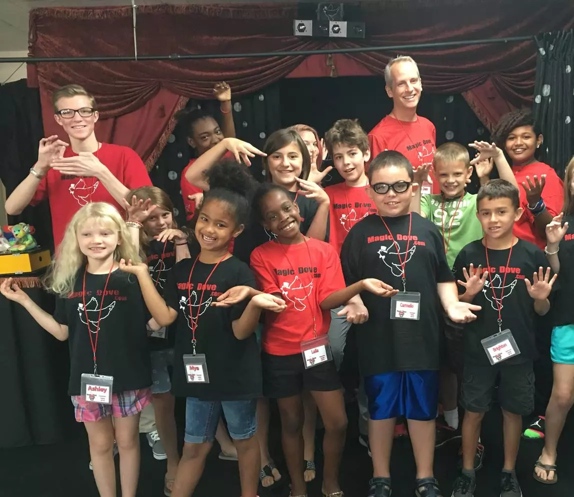 A group of children posing together with the badge