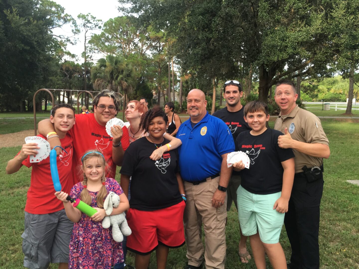 A group of people posing for a picture in a park.