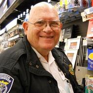 A man in a police uniform standing in a store.